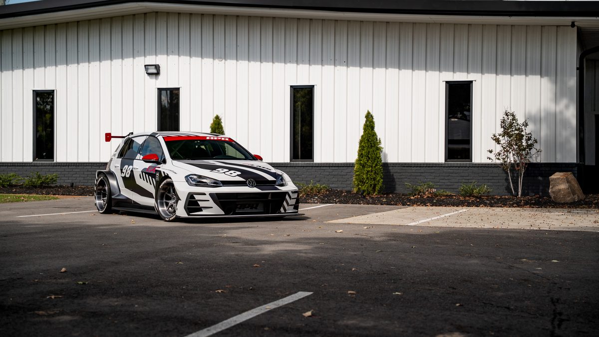 APR's number 98 Volkswagen Golf race car parked outside a white building