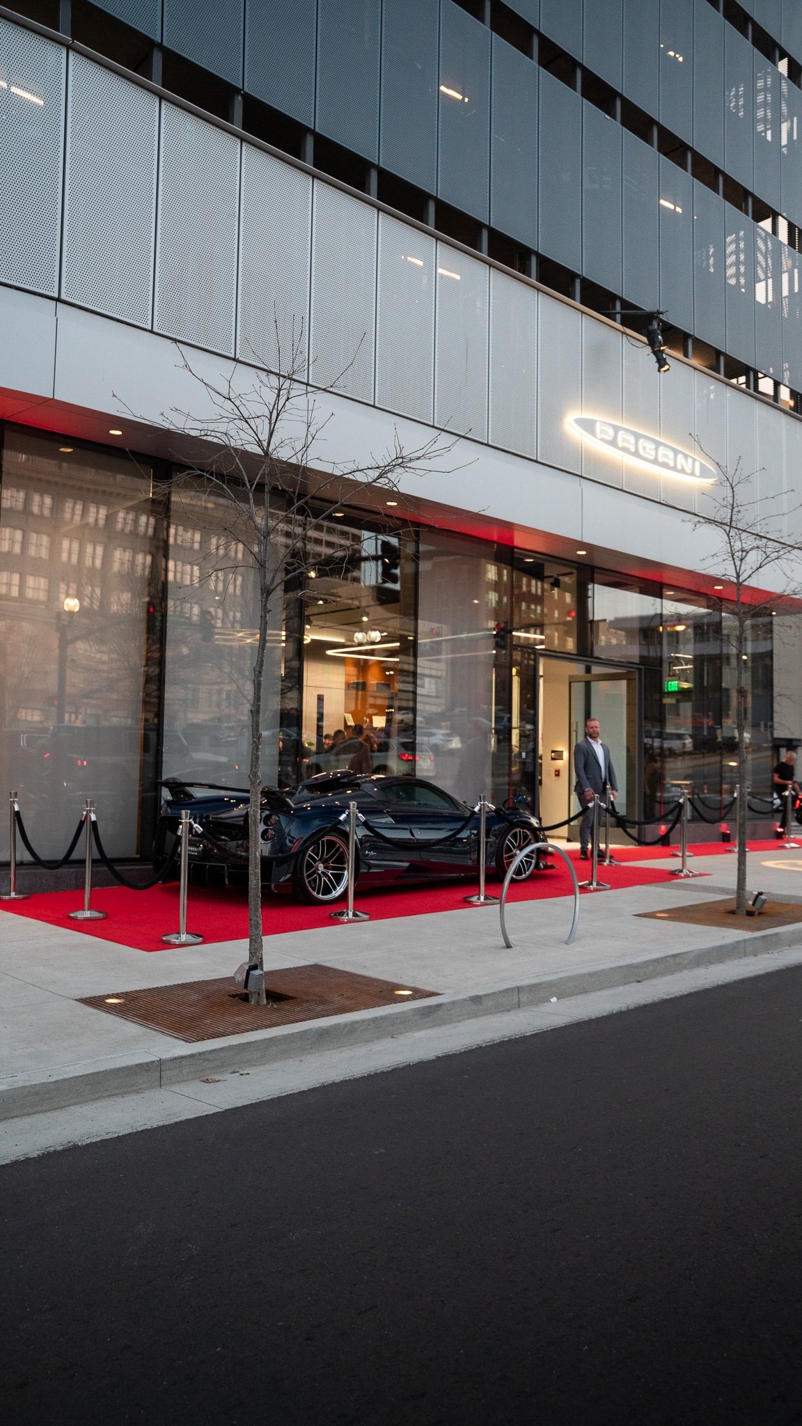 A Pagani on a red carpet outside the Pagani of Nashville showroom at dusk, shot by Runn Media
